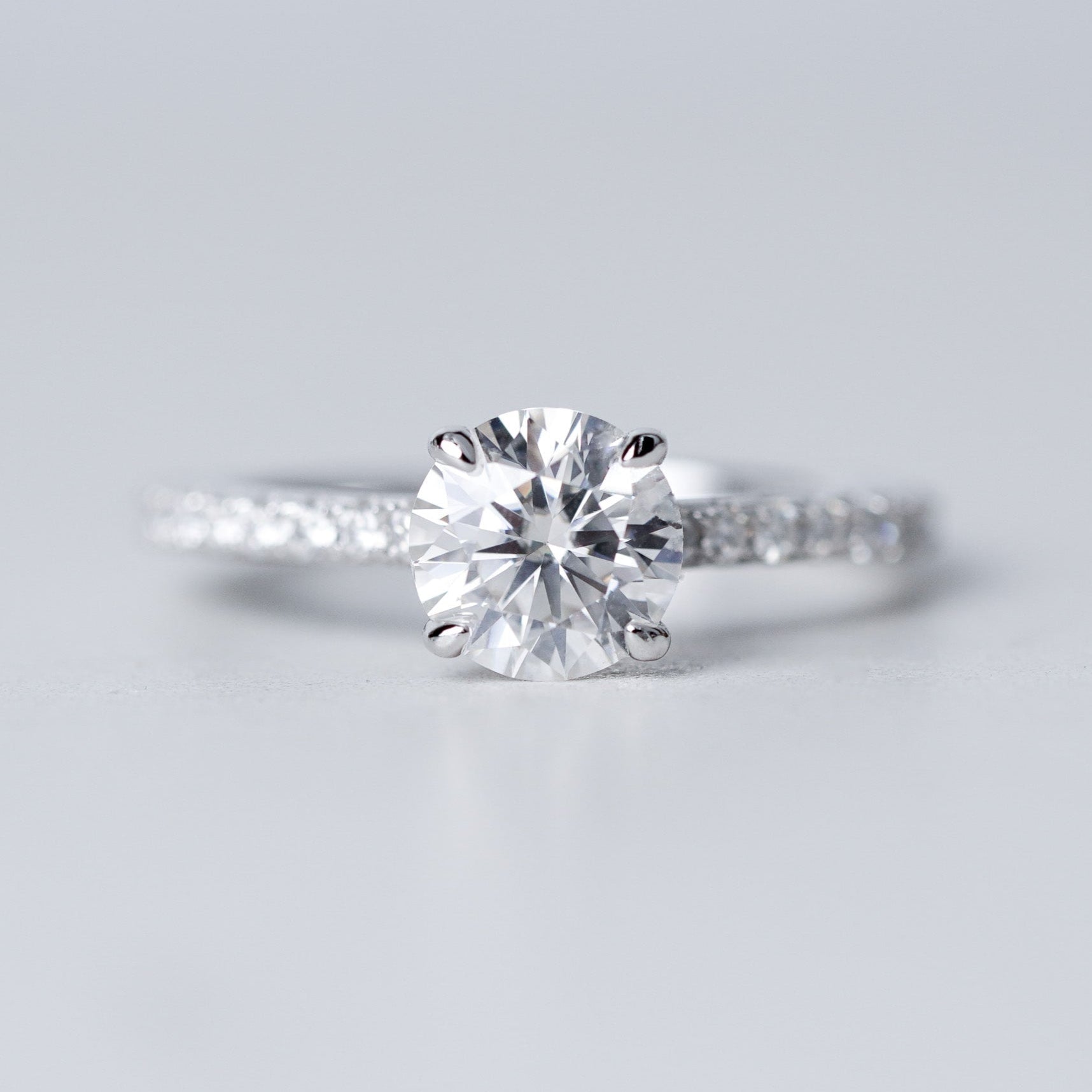 Moissanite Solitaire Engagement Ring - With Pave Side Stone