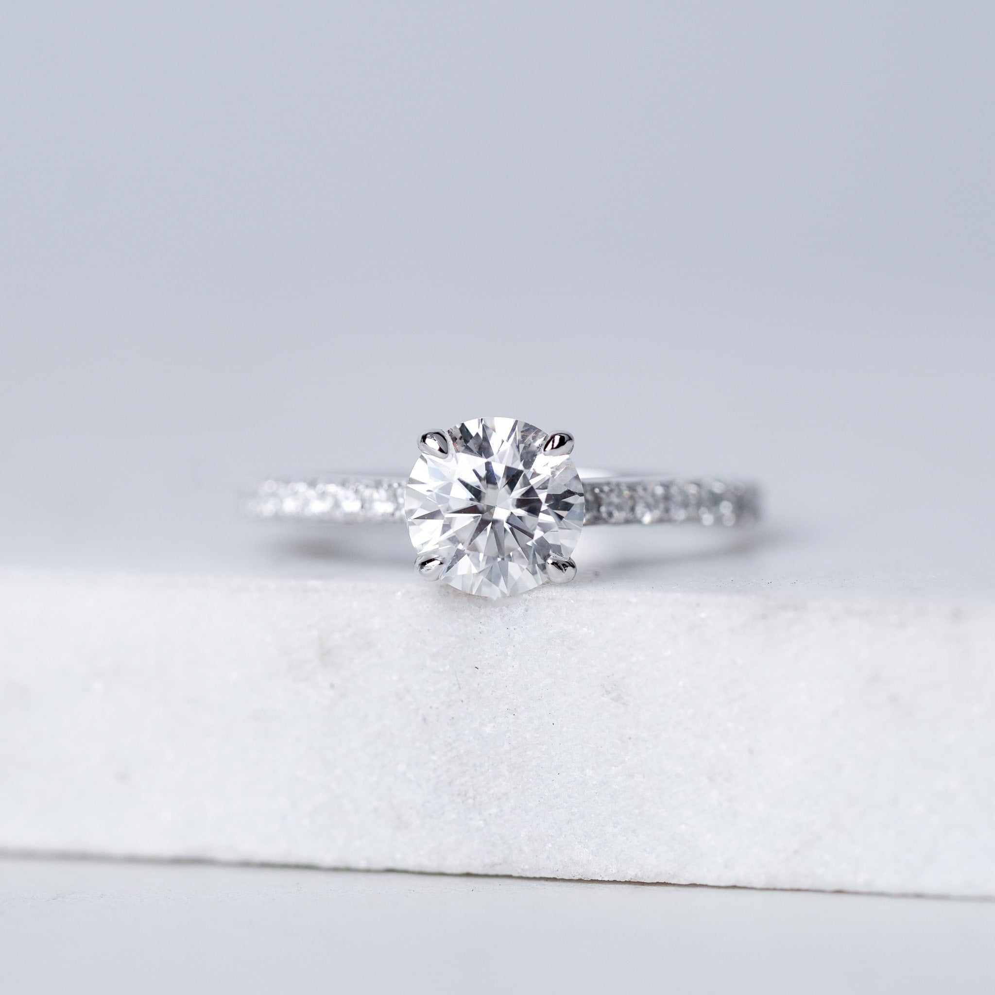 Moissanite Solitaire Engagement Ring - With Pave Side Stone