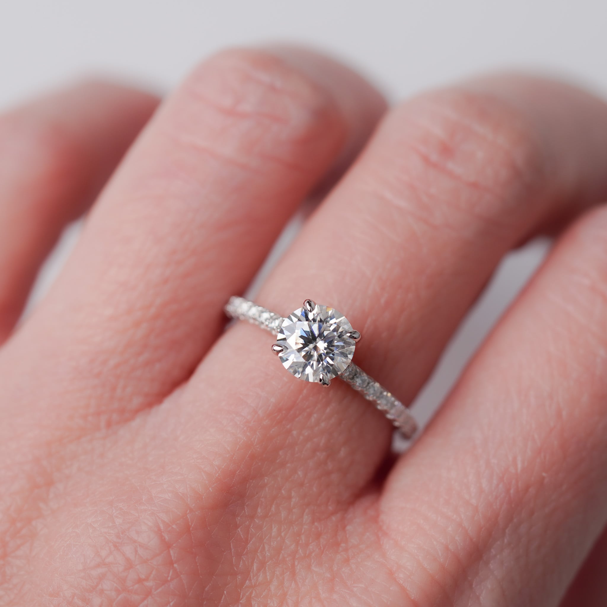 Moissanite Solitaire Engagement Ring - With Pave Side Stone