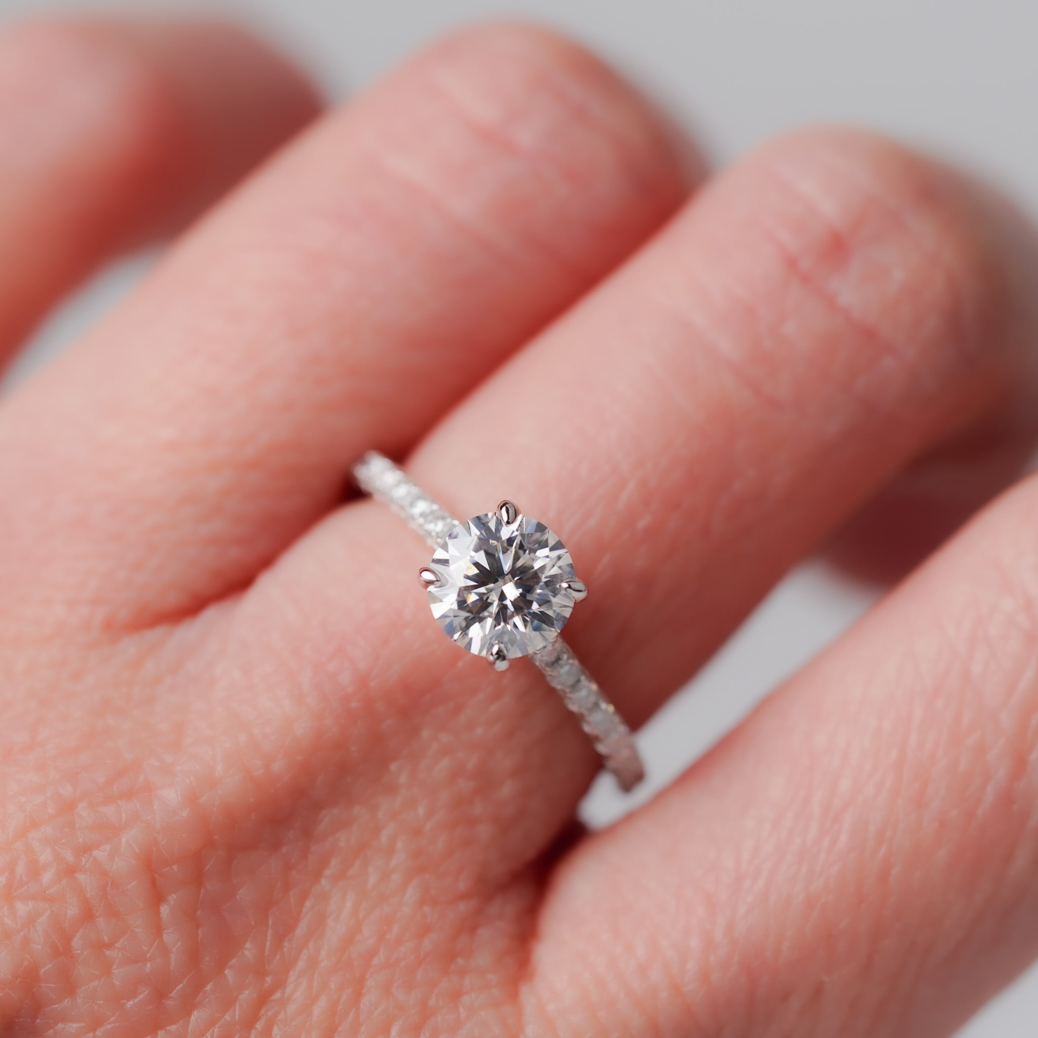 Moissanite Solitaire Engagement Ring - With Pave Side Stone