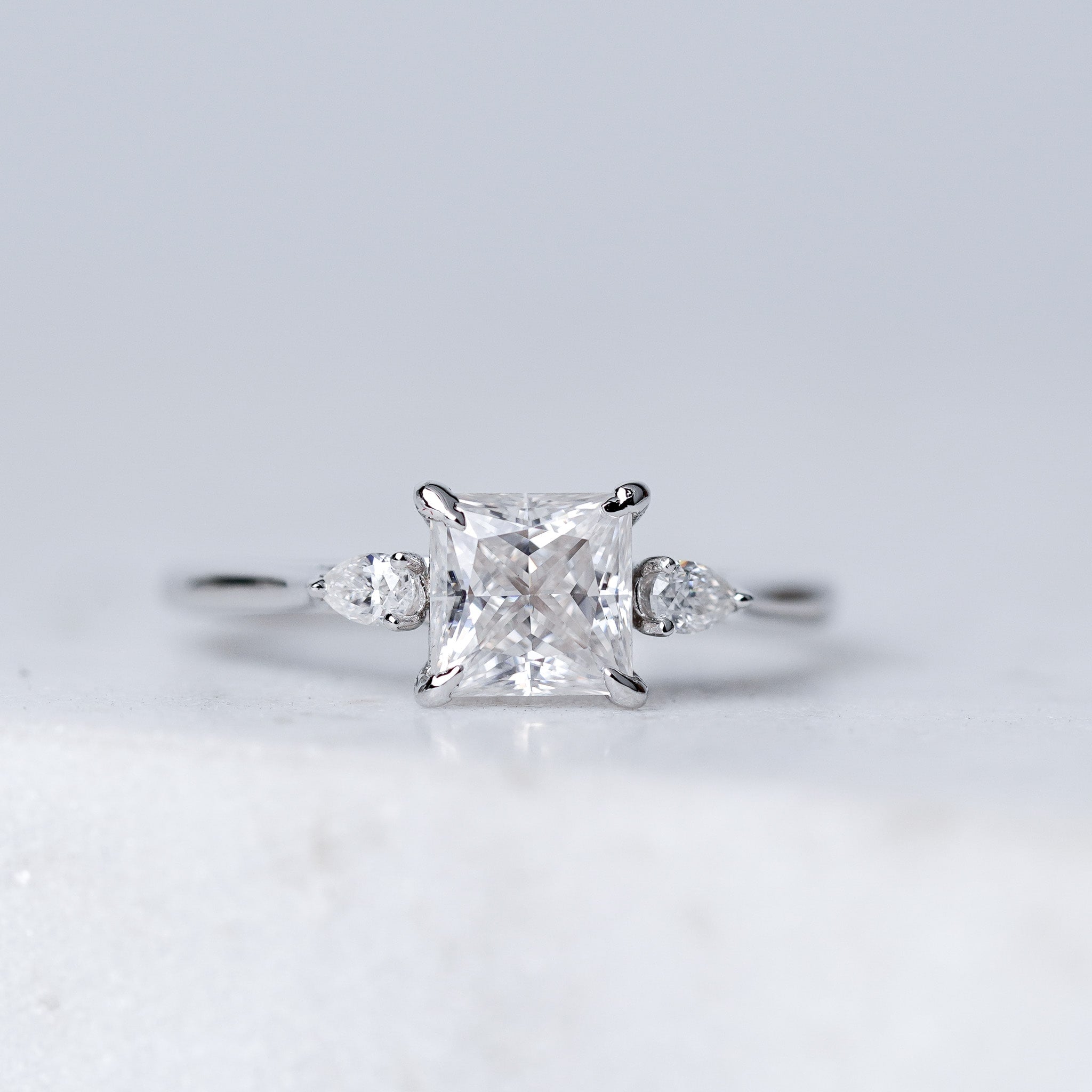 Princess Moissanite Ring - With Pears Side Stone
